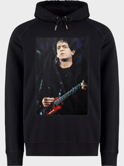 pack shot with patch showing a photograph of Lou Reed performing on stage
